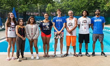 instructor team standing in a line outside of a pool