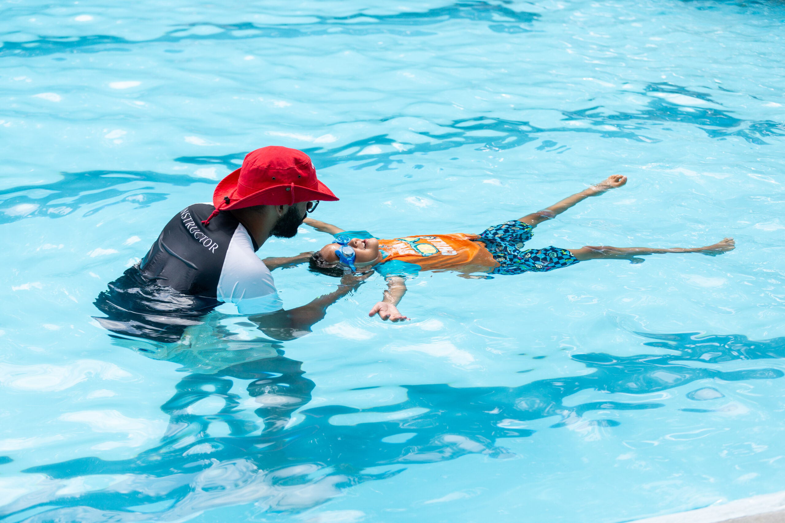 Water Safety Instructor working with Beginner swimmer